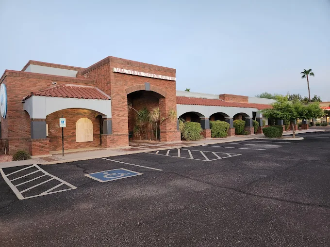 Val Vista Executive Office Suites building exterior showing professional brick architecture with covered parking and landscaping